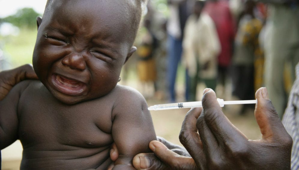A crying baby receives a vaccination