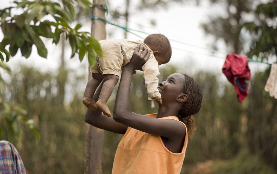 A mother plays with her young son in the Kenyan village of Mwea