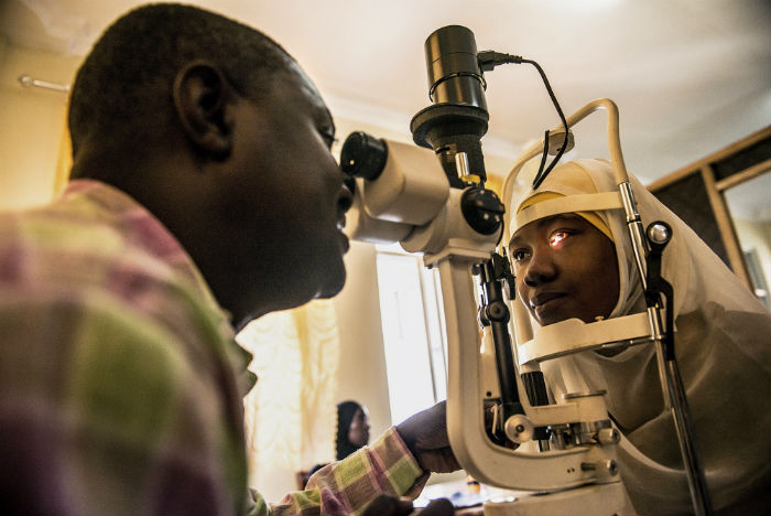 pediatric opthamologist conducts eye examinations