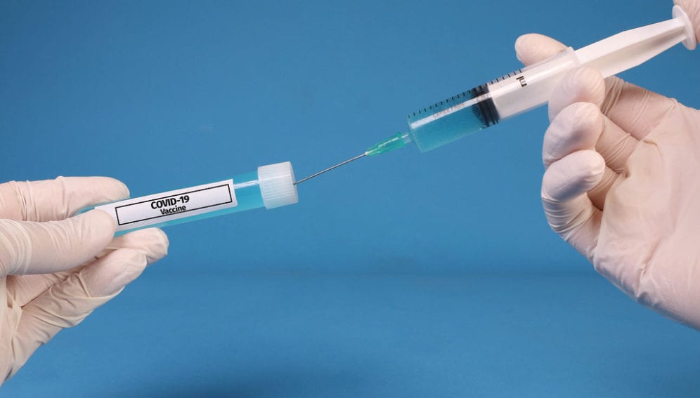 "Doctor or nurse filling a syringe with Covid-19 Vaccine" by wuestenigel is licensed under CC BY 2.0