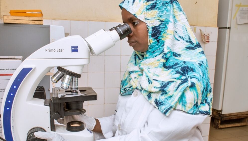 A microscopist in Niger conducts malaria microscopic examination.

More:

 Photo Credit: PMI Impact Malaria. Original public domain image from <a href="https://www.flickr.com/photos/pmigov/51396971747/" target="_blank" rel="noopener noreferrer nofollow">Flickr</a>