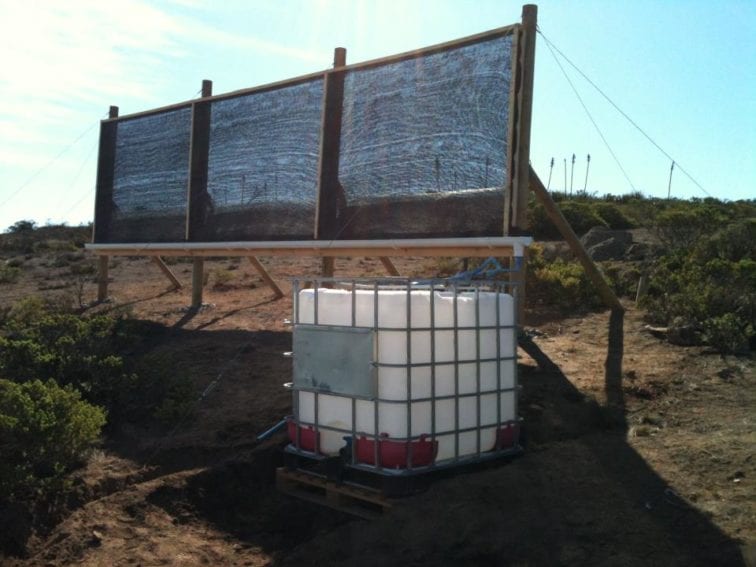 One of the two 17 square metre fog-catchers that harvest water for producing Atrapaniebla beer. The three main parts of the fog catcher are a structure with mesh, a gutter and a tank to store the water.
