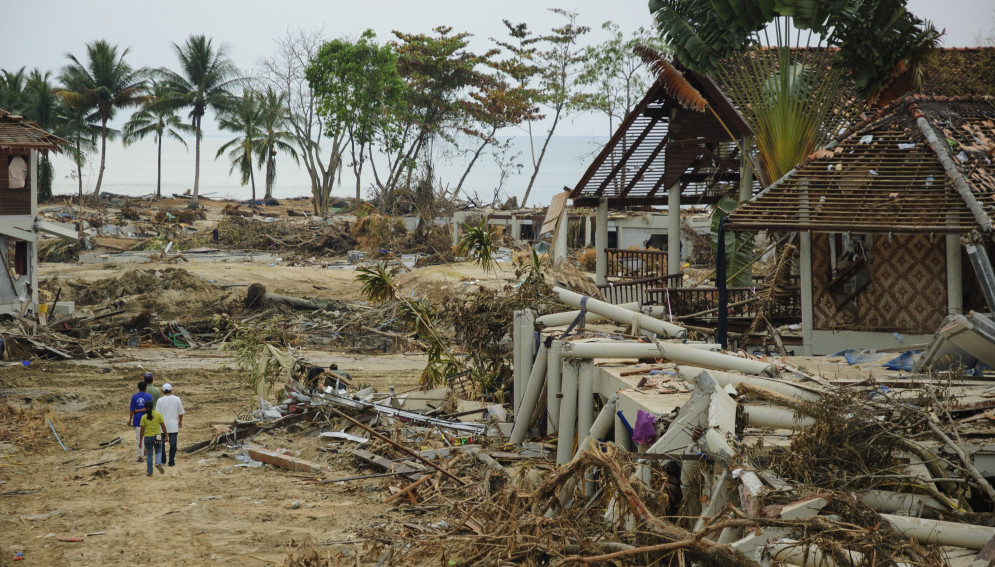People walk through the remains of a beach resort on Khao Lak several days after the December 26, 2004 tsunami that devastated Southeast Asia
