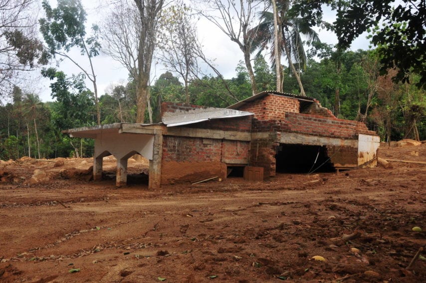 A two-storied house buried up to its roof on the Ramasara mountain, Egalpitiya. The landslide, triggered by three days of incessant rains, sent boulders hurtling down the mountain.
