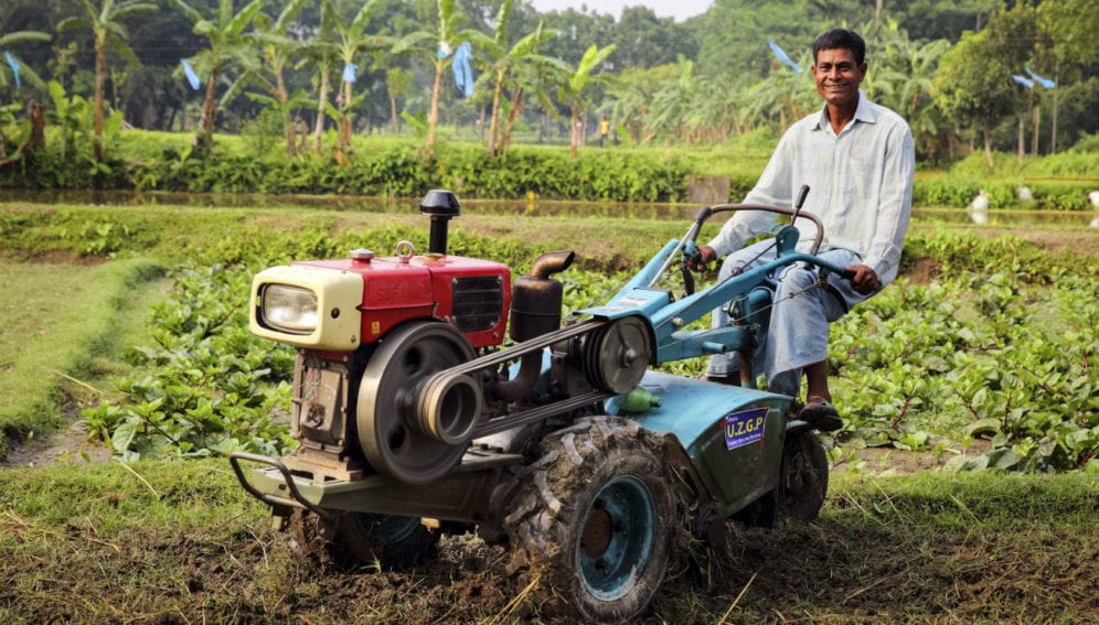 Abdul Khaleq with the agricultural machine he was given by a government NGO