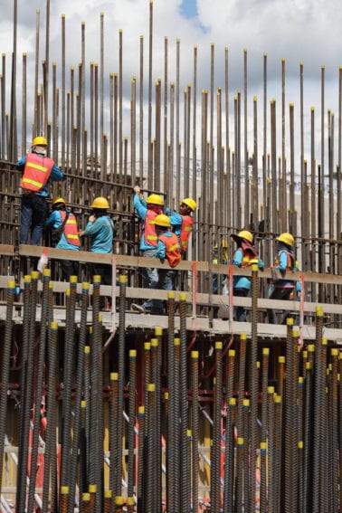 Thai and Lao workers insert reinforcing bars before concrete is poured to form the dam walls
