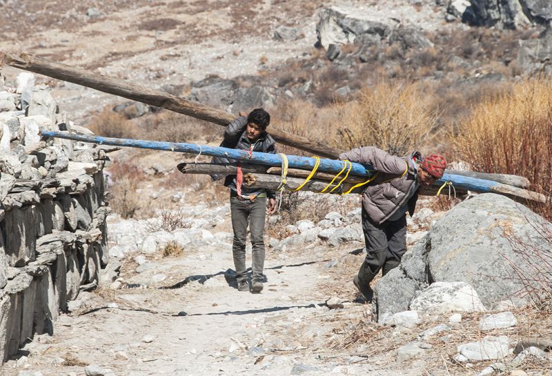 Porters carry construction materials to Langtang Valley, which is accessible only by foot. It takes about three days to walk from the nearest town to the village of Langtang, making quake recovery extremely expensive and challenging
