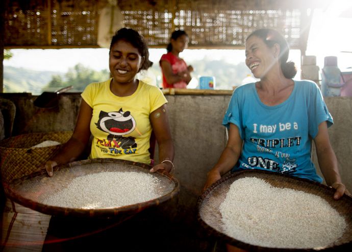 Two women prepare rice