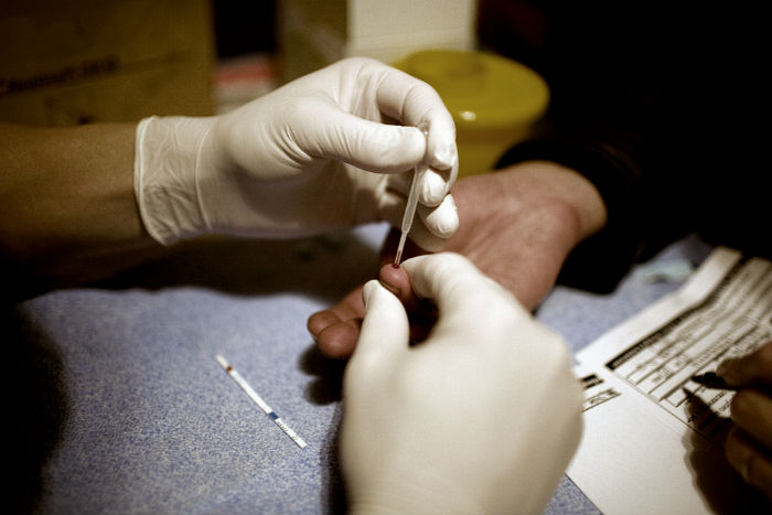 worker takes a blood sample