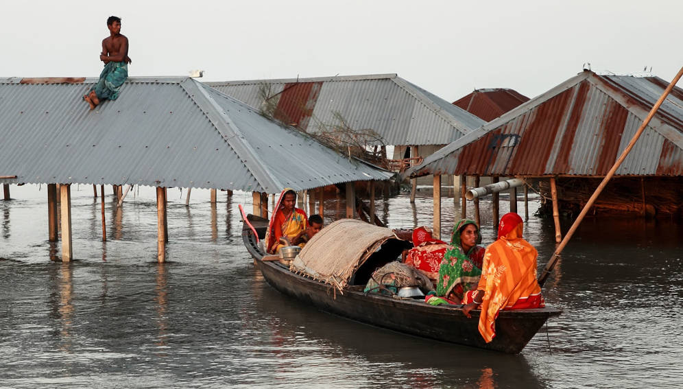 Due to climate change hundreds of houses were flooded by excess rainwater on 22nd June 2022. So thousands of homeless people are living in boats.. Region reversing on climate action, stagnant on clean energy. Photo by Muhammad Amdad Hossain / WMO.