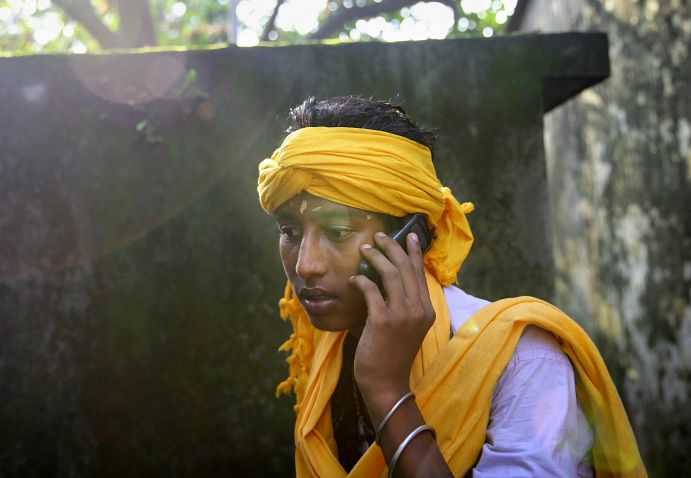 A Bangladeshi Hindu, uses a mobile phone