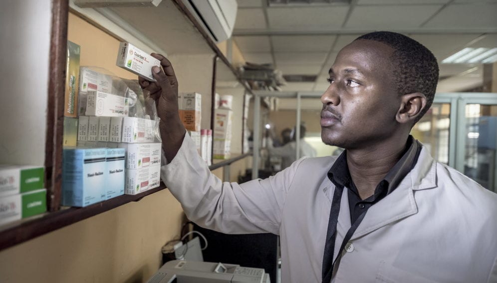 A member of staff checks a malaria medication