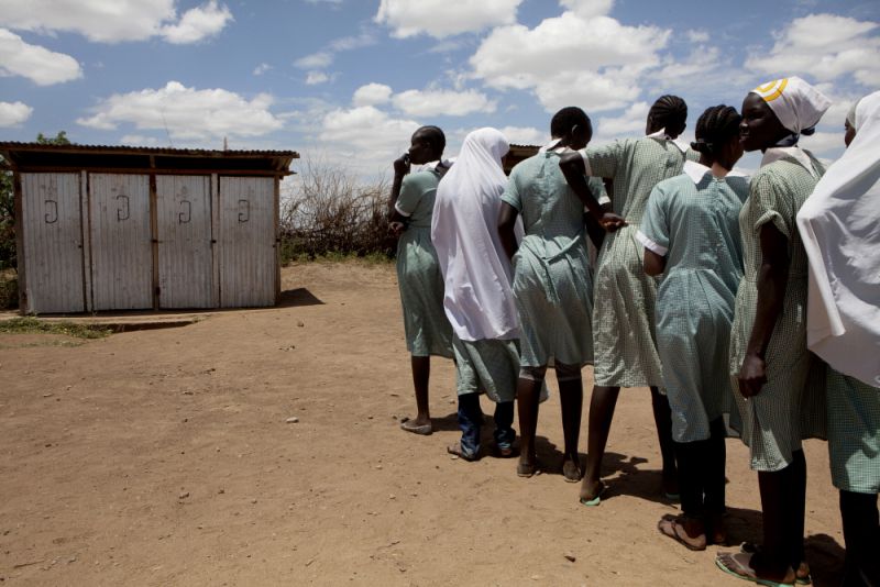 Girls queue to use the toilet facilities at the Unity primary