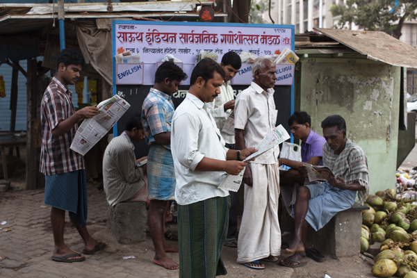 Men reading newspaper India