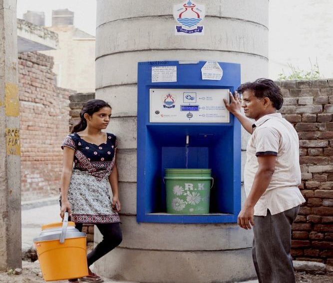 People using a water ATM in the suburb of Dwarka