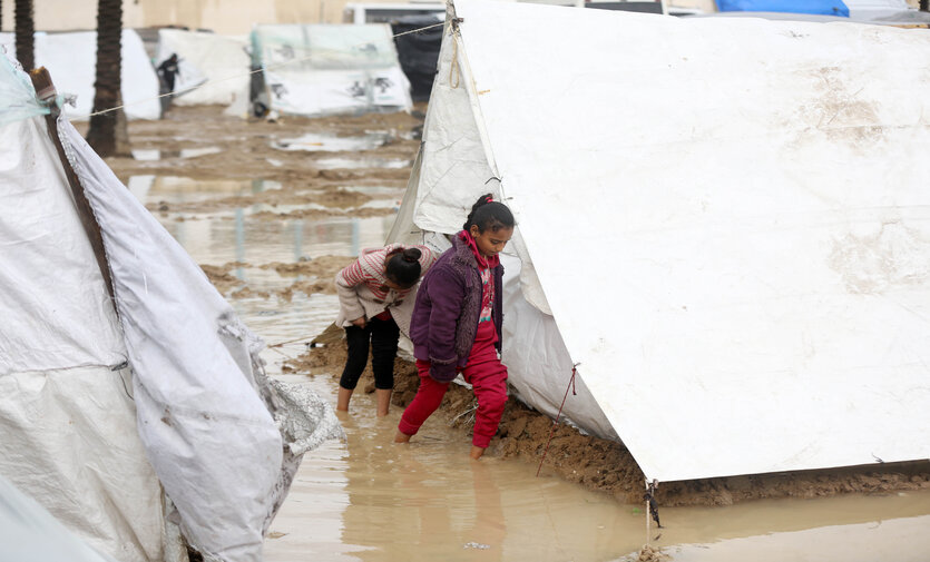 Movement between the camps is made difficult due to the puddles of water left by heavy rains.

