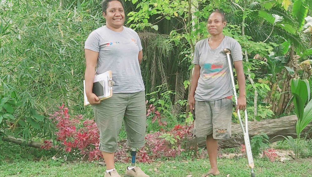 Almah Kuambu with a prospective assistive technology user during a National Orthotic and Prosthetic Services outreach programme in Popondetta in southern Papua New Guinea.
