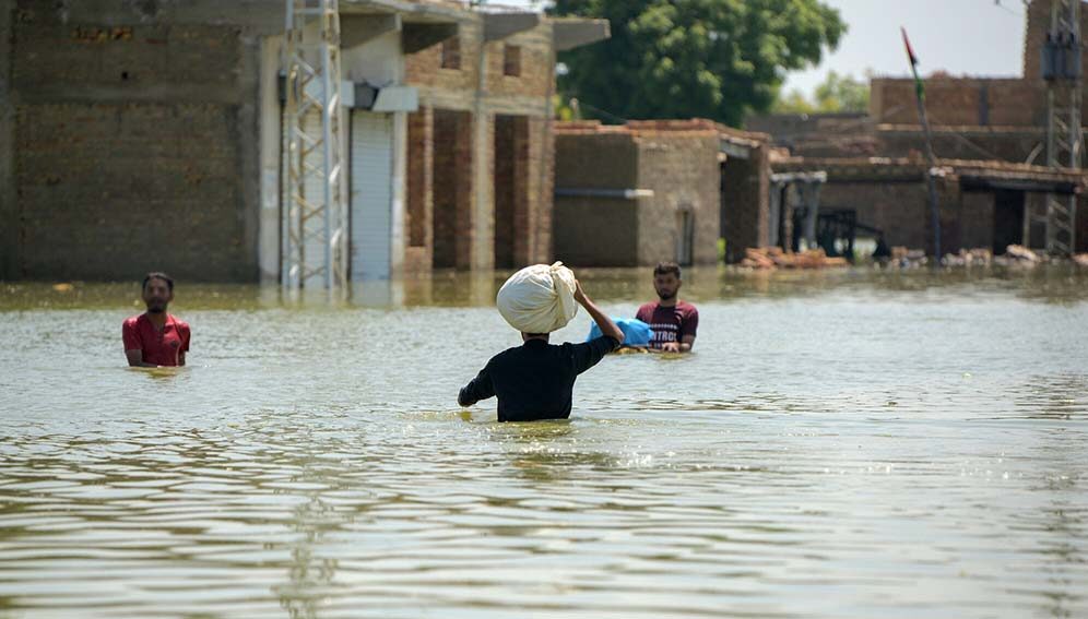 Men wade through the floodwater in Khairpur Nathan Shah, Dadu Sindh, Pakistan, on 2 September 2022.