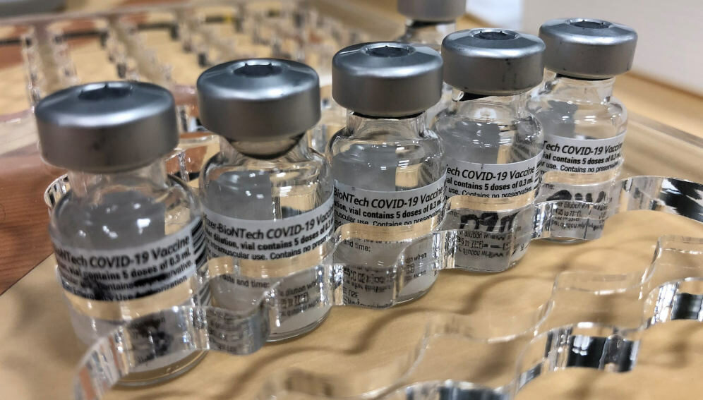 Pfizer vaccine vials in an acrylic tray