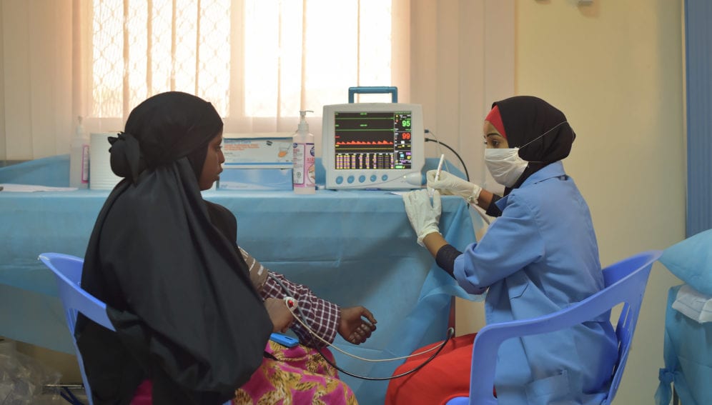 doctor takes the vital signs of a patient in Mogadishu
