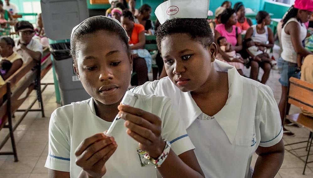 Haiti Nurses with a vaccine