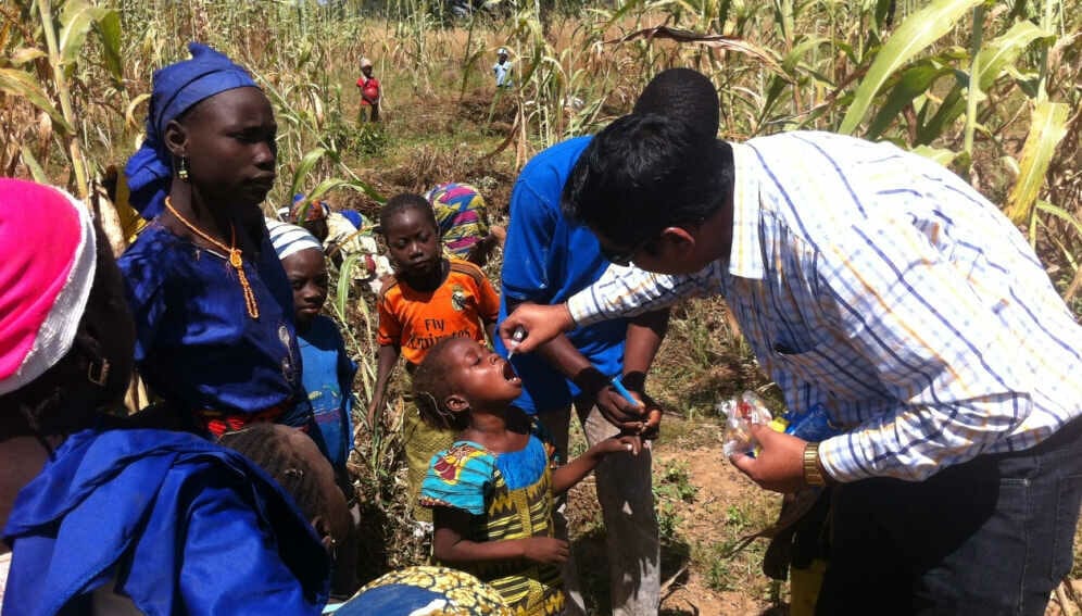 Administering vaccine on a farm in Nigeria