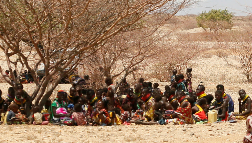 Women and children try to shelter from the hot noon sun in Kapua, Turkana County, northwest Kenya, in 2017. Repeated failed rains this year have left the area facing a devastating drought crisis.