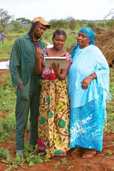 The power of ICT: One of the farmers trained by Farm Africa is using a tablet computer to train others farmers in growing improved sesame in Tanzania
