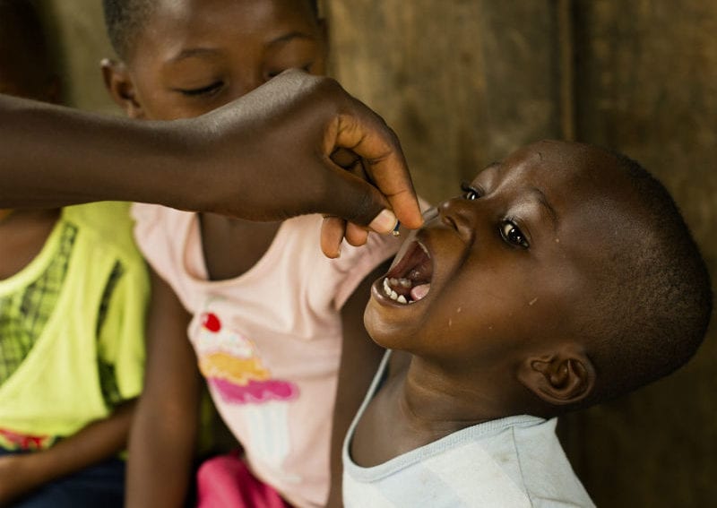A child receiving a dose of vitamin