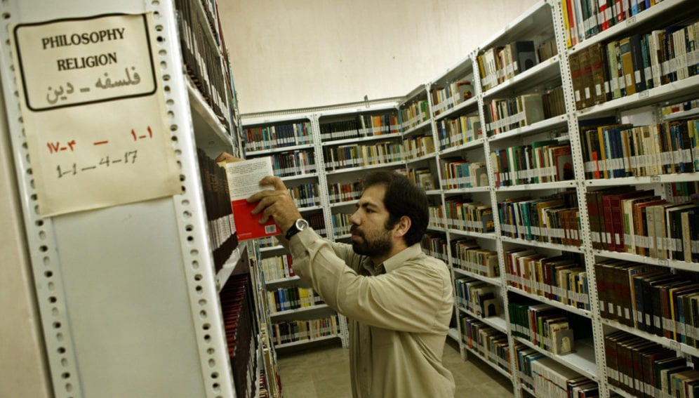 A student searches the book shelves