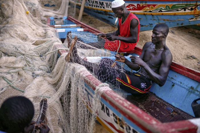 Fishermen repairing their nets