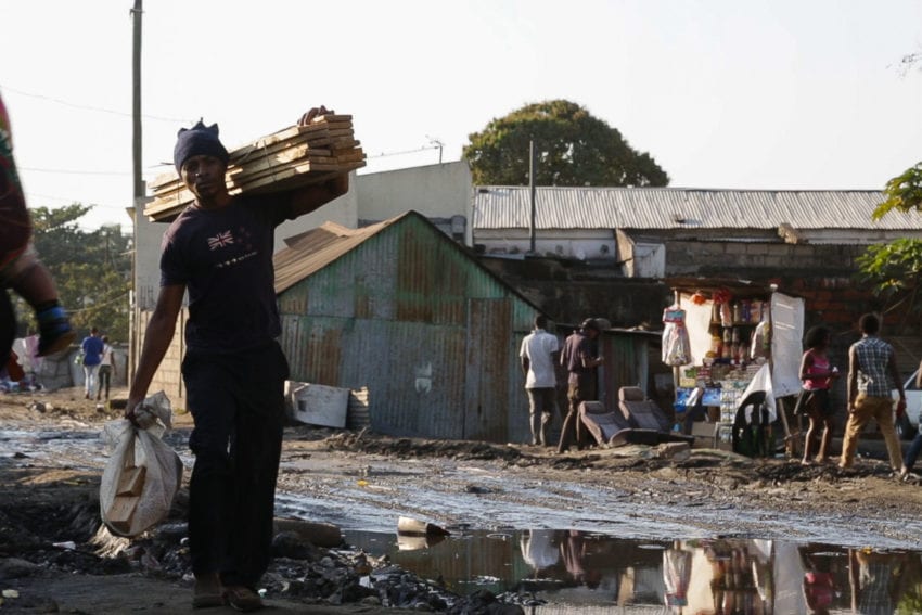 A man walks past sewage on a street in Mafalala, a poor settlement near the city centre. Piped water and sewage systems are only available to a quarter of Maputo’s population
