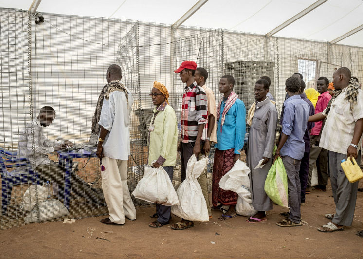 Residents queue for a food rationa at Dedaab Refugee Camp