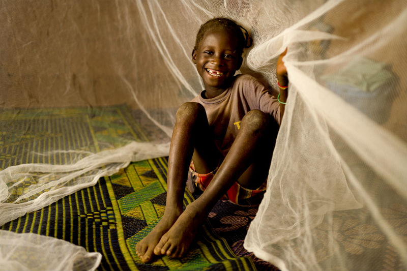 Sainata Ouedraogo under her mosquito net at her home