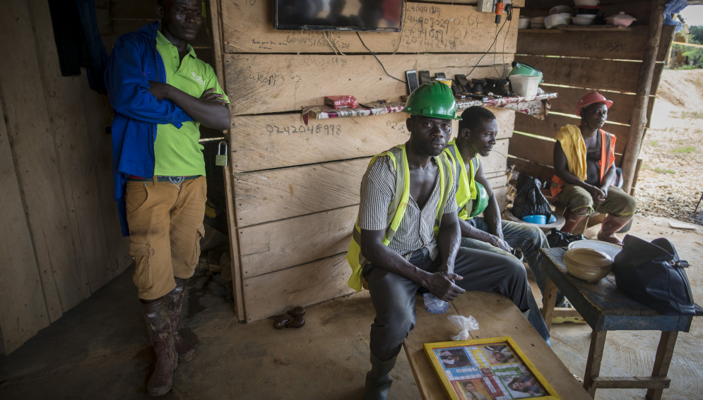 Mine workers gather for a meal at Babasala mining site-a legal mining site- in Kyebi, eastern region of Ghana. 
