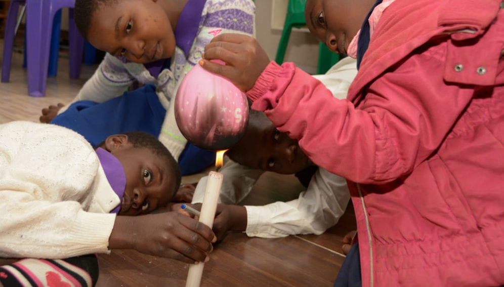Schoolchildren experiment with a  candle