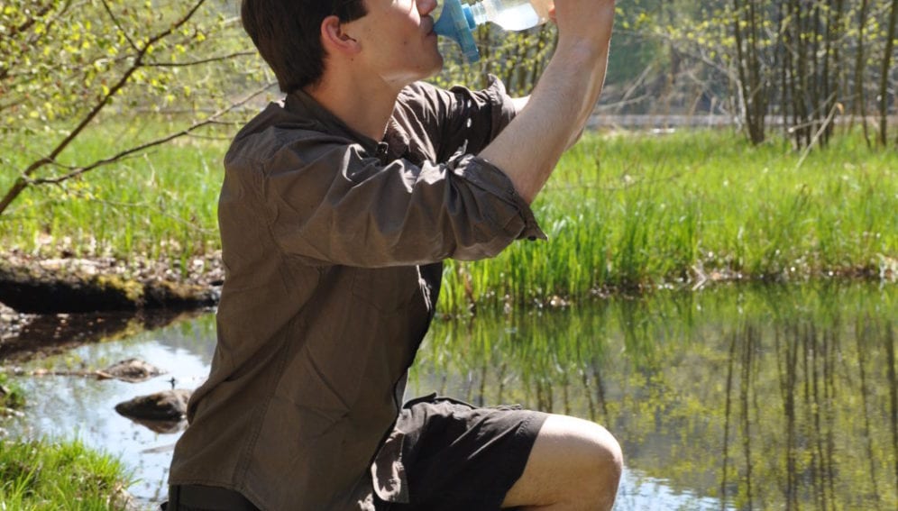 A man taking water