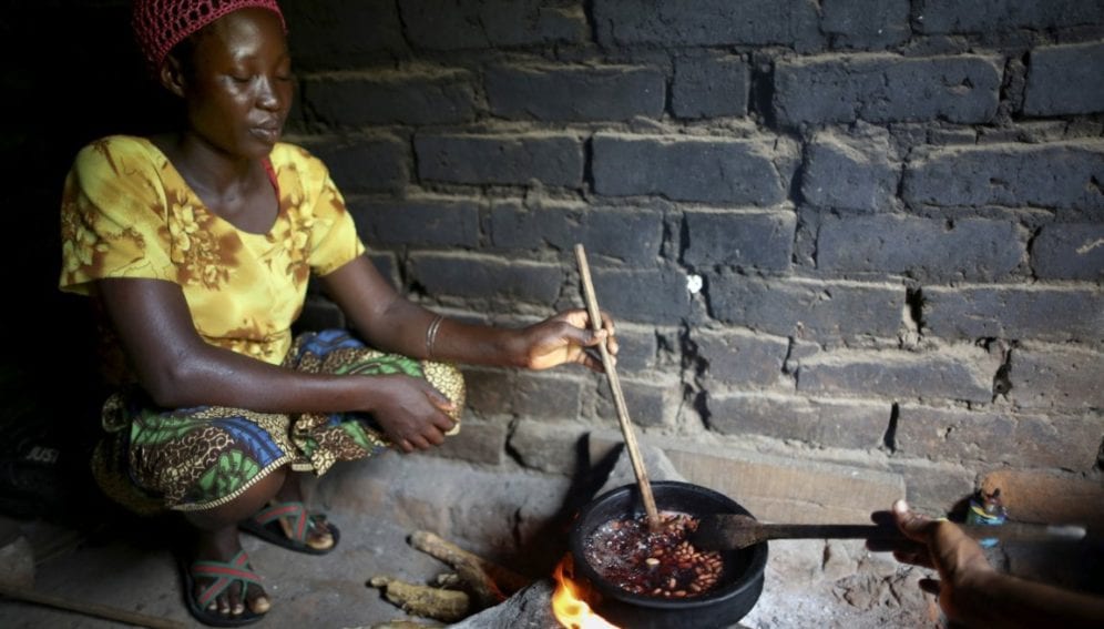 woman cooks a pot of beans
