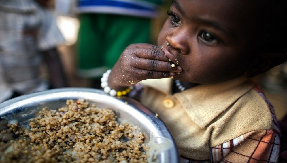 A child eats lentils