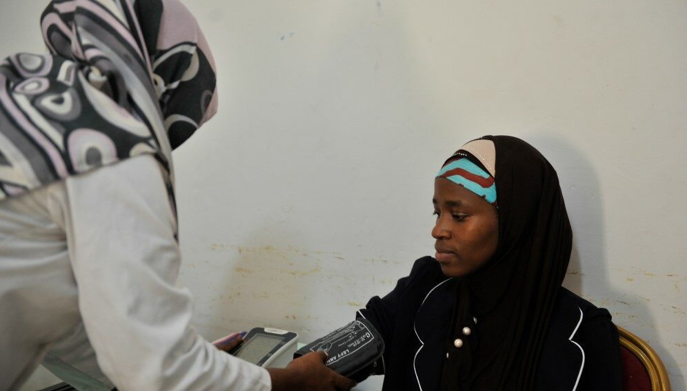 A staff member of the Blue Star Hospital takes the vital signs of a patient in Mogadishu