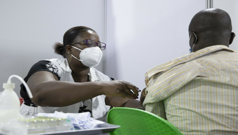 Healthcare worker provides COVID-19 vaccination