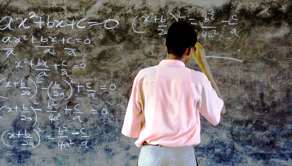 A student solves a mathematics equation. Photo: © Jonathan Ernst/World Bank.