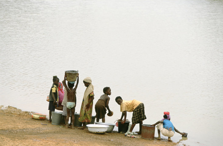 Children collect water from a lake. This lake in northern Ghana is also used by cattle, increasing the risk of contamination
