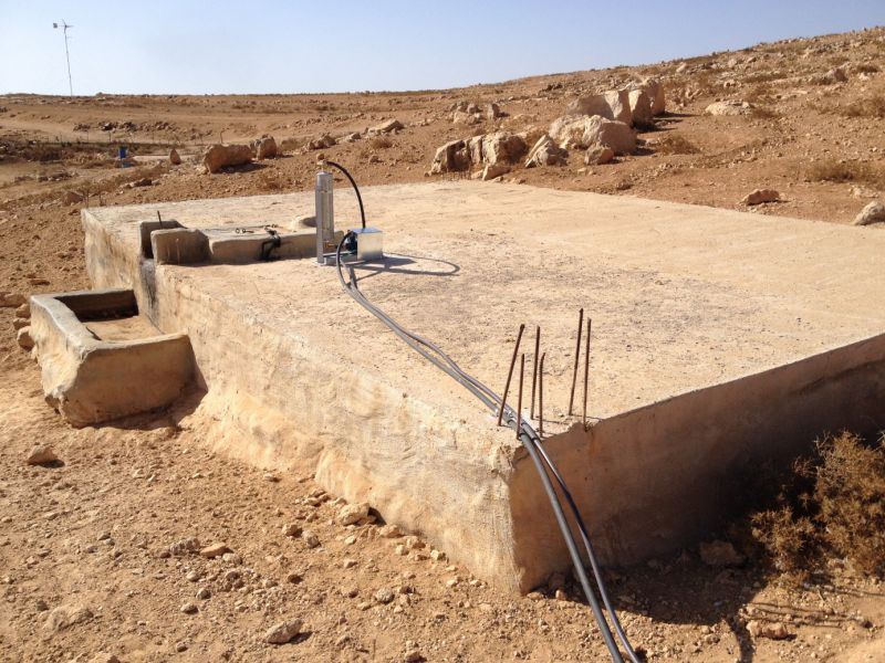 A pump and priming tank on top of a cistern in which rainwater is stored. Pipes carry water from the cistern to homes, where taps are installed. Before reaching the tanks, the water goes through particle filters to clean it. The new systems mean that children no longer have to carry heavy loads of water to their homes.

