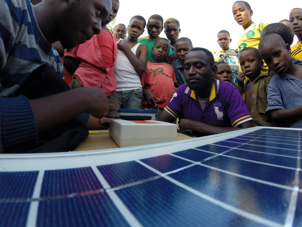 A demonstration of Eternum Energy’s Solaris mobile phone charging station in a village in Mwanza region, northern Tanzania. Entrepreneurs can rent the kit and charge local people to use it. As well as phones, the solar units can be used to charge lamps and other devices that have USB sockets
