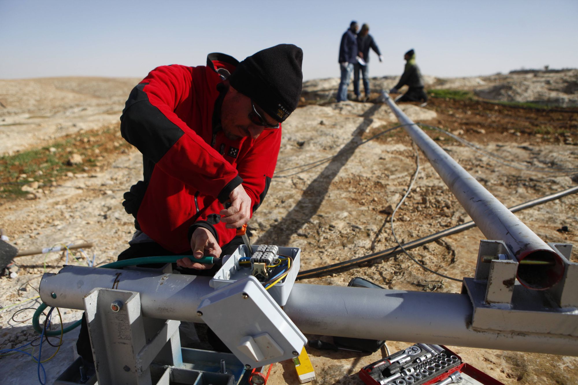 A technician wires up a wind turbine before installation in the South Hebron hills. The villages here are in Area C of the West Bank, which is under Israeli control. Elad Orian, Comet-ME’s cofounder, says Israel does not provide Palestinians with basic services “as part of a political campaign to try and drive them off their land”
