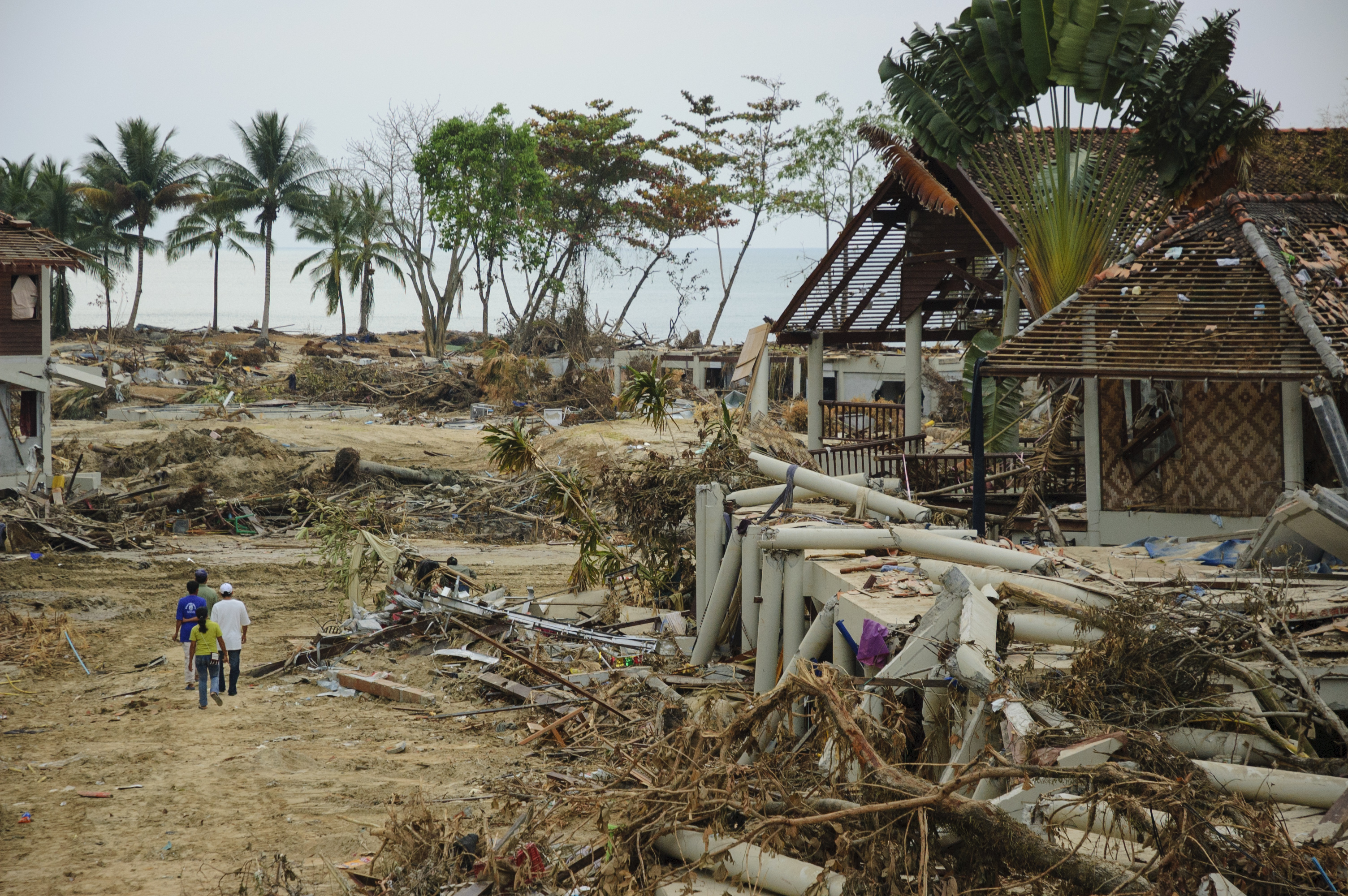 People walk through the remains of a beach resort on Khao Lak several days after the December 26, 2004 tsunami that devastated Southeast Asia
