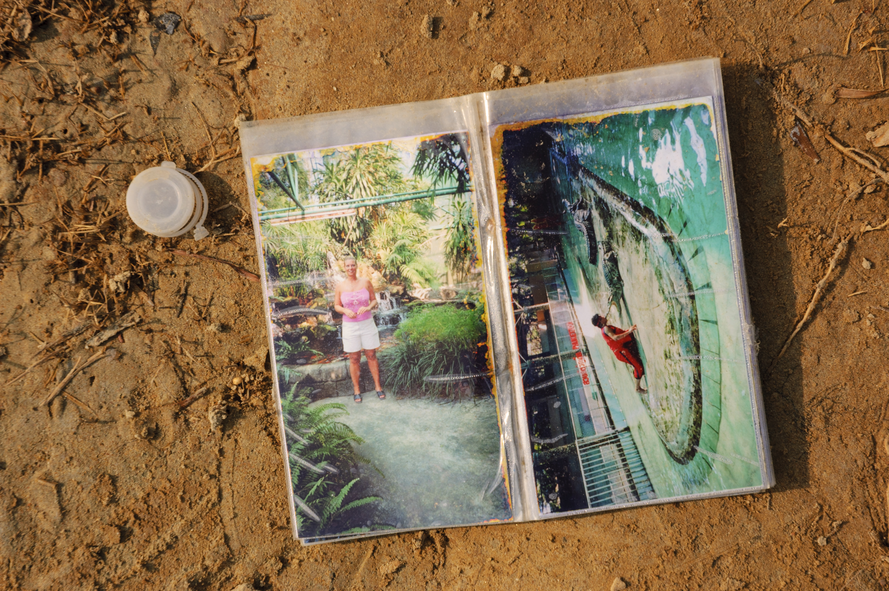 Photos of tourist litter the beach of Khao Lak following the massive tsunami