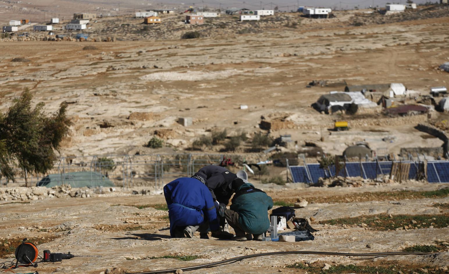 An off-grid solar system in Sha’eb el Buttom, a village in the South Hebron hills. In the background is an illegal Israeli settlement that Israel has fully connected to the grid
