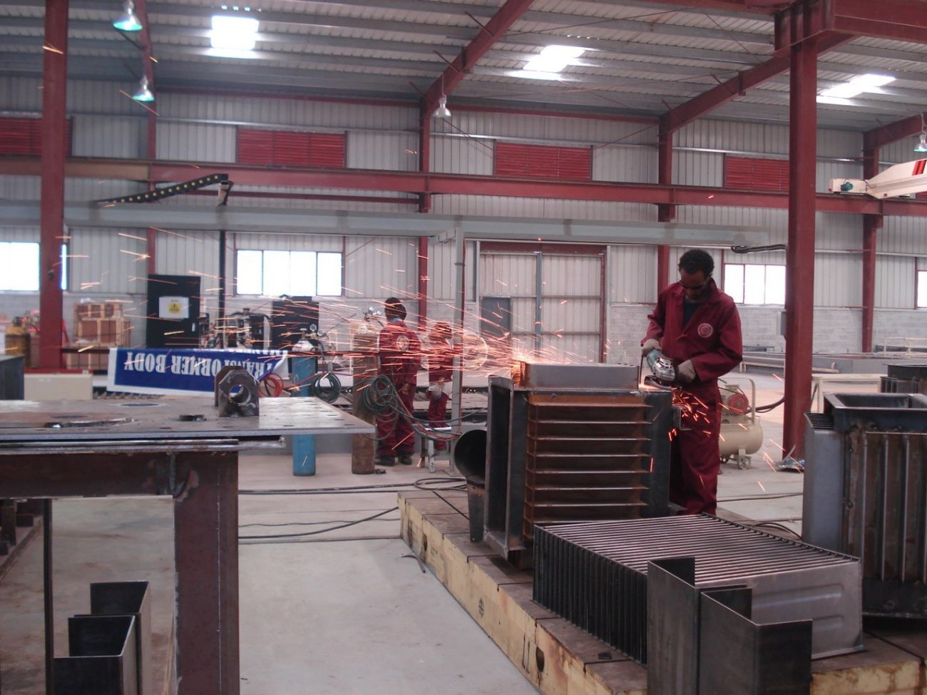 In the factory’s main hall, workers assemble parts into the transformer casings. Transformers are used to change the voltage of an electricity supply
